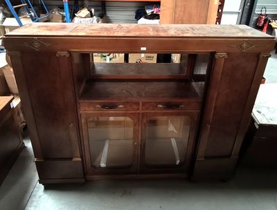 a wooden cabinet with glass doors in a room