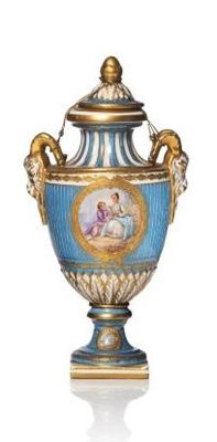 a blue and gold vase with a picture of a woman on it