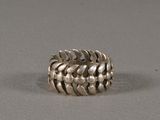 a close up of a silver ring on a gray surface