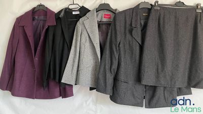 three suits hanging on a clothes rack in front of a white backdrop