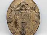 a close up of a gold plate with a coat of arms on it