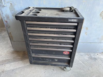 an old tool box that is sitting on the floor