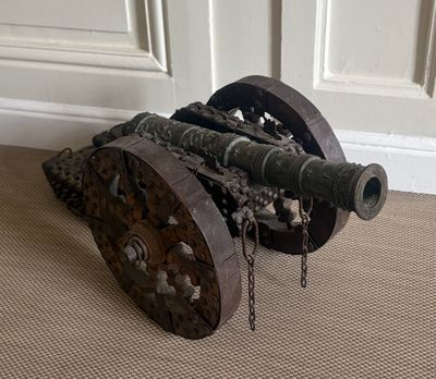 a cannon sitting on the floor in front of a door