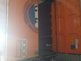 a large orange truck parked in a garage