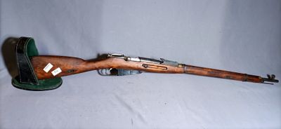 an old rifle with a wooden barrel and a green case