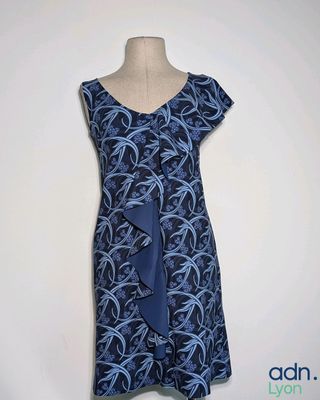 blue and black dress with a blue tie on a mannequin dummy