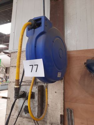 a blue hose attached to a wall next to a yellow hose