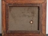 an old picture frame with a small hole in the middle of it