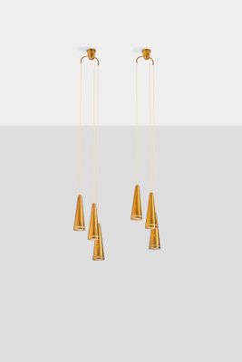 three gold colored lights hanging from the ceiling