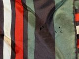 a close up of a striped shirt with holes in it