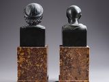 a pair of bronze busts of a man and a woman
