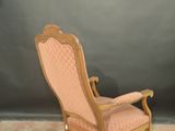 a pink chair that is sitting on a carpet
