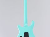 a blue electric guitar hanging from the ceiling