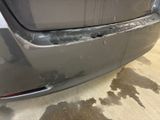 a car that has been dented and is in the garage