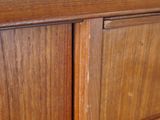 a close up of a wooden cabinet with a knob on it