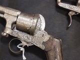 two old guns that are on display on a table