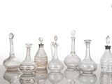 many glass bottles that are lined up on a table