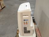 a white refrigerator sitting on a pallet in a warehouse