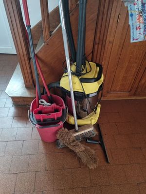 a mop, bucket, broom, and mop holder on the floor