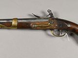 a close up of a gun on a table with a white background