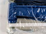 a blue stapler sitting on top of a piece of plastic