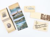 many old photos and postcards on a white surface