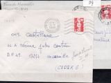 two envelopes with stamps on them sitting on a black surface