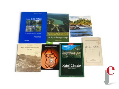several books are sitting on a white surface next to each other