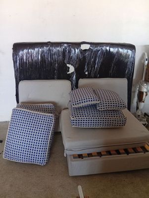 a bed with a pull out bed frame and pillows on it