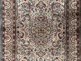 an antique persian rug with a floral design and fringe fringes