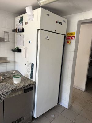 an image of a kitchen with a refrigerator and a sink