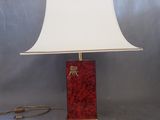 a red lamp with a white shade on it