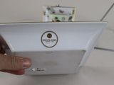 a person holding a white plate with a picture on it