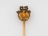 a gold colored stick with a bird on it