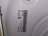 a close up of a white washing machine in a bathroom
