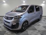 the silver van is parked on a checkered tile floor