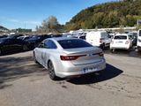 a silver car parked in a parking lot next to other cars