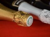 bottles of champagne are lined up on a red surface