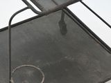 a metal chair that is sitting on a white surface