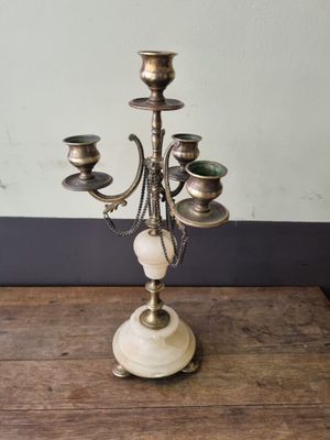 an antique brass candelabra with marble balls and candles