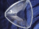 a clear glass bowl on a blue cloth
