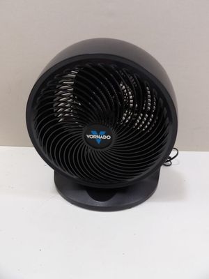 a small black fan sitting on a white table