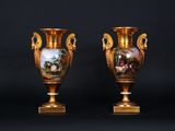 pair of antique vases with painted scenes on them against a black background