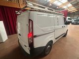 a white van with a ladder on the back of it
