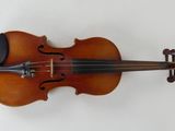 a close up of a violin on a white surface
