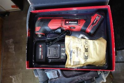 a box with a cordless drill and other tools in it