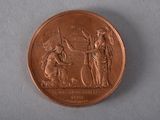 a close up of a coin with a woman and a man on it