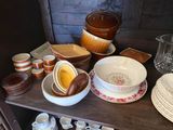 many bowls and plates on a shelf in a room