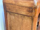 a wooden cabinet with a marble top on it