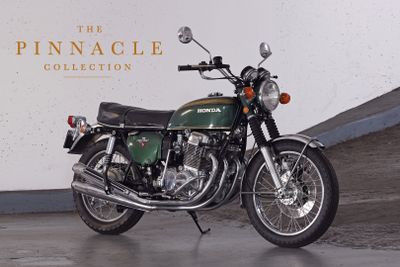 a green motorcycle parked in front of a white wall